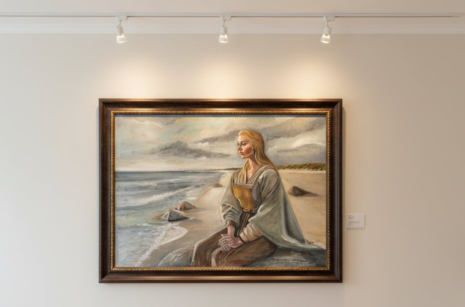 Painting of a woman sitting on a beach with a scenic background